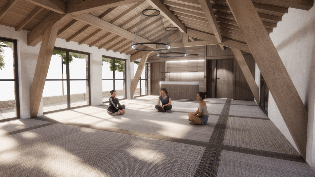 Trois femmes assises en tailleur conversent dans une vaste pièce lumineuse. Le contexte : un plafond en bois, de grandes baies vitrées donnant sur la verdure et un comptoir moderne.